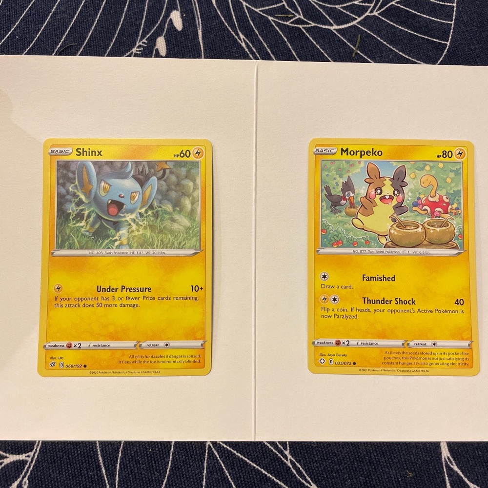 Two Pokémon cards, shinx and morpeko